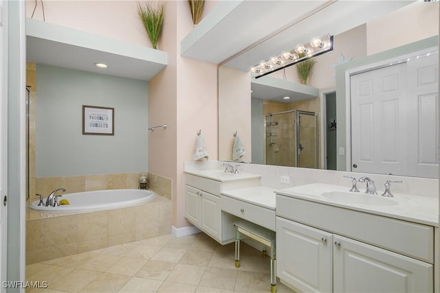 full bathroom featuring double vanity, a sink, a shower stall, a bath, and tile patterned floors