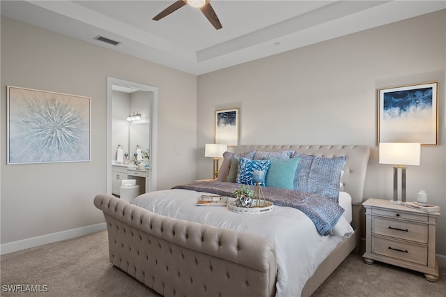 carpeted bedroom featuring ceiling fan and ensuite bath