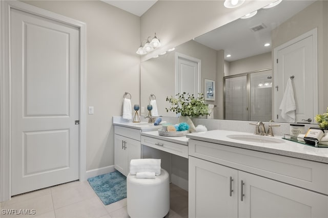 bathroom featuring tile patterned floors, vanity, and a shower with door