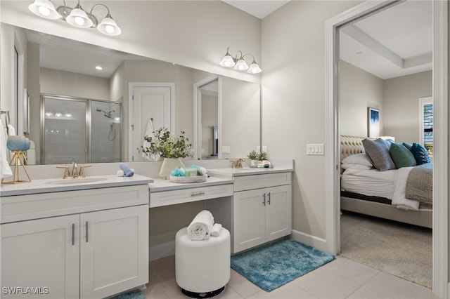 bathroom featuring a shower with shower door, vanity, and tile patterned flooring