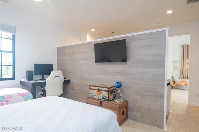 bedroom with light colored carpet and crown molding