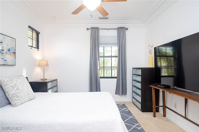 carpeted bedroom featuring ceiling fan, multiple windows, and ornamental molding