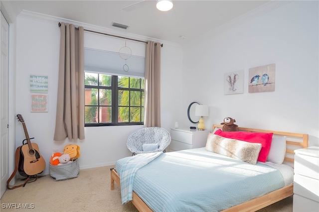 carpeted bedroom with ceiling fan and crown molding