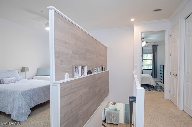 carpeted bedroom featuring ceiling fan and crown molding