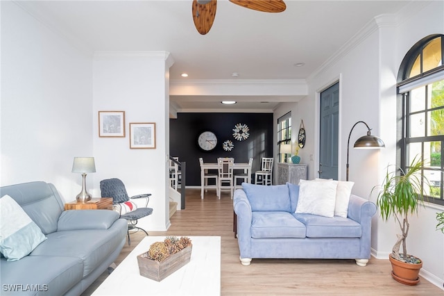 living room featuring ornamental molding, ceiling fan, and light hardwood / wood-style floors