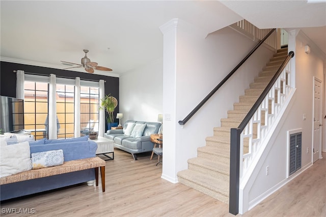 living room with ceiling fan, light hardwood / wood-style floors, and crown molding