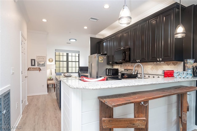 kitchen featuring light wood-type flooring, dark brown cabinetry, crown molding, and stainless steel appliances