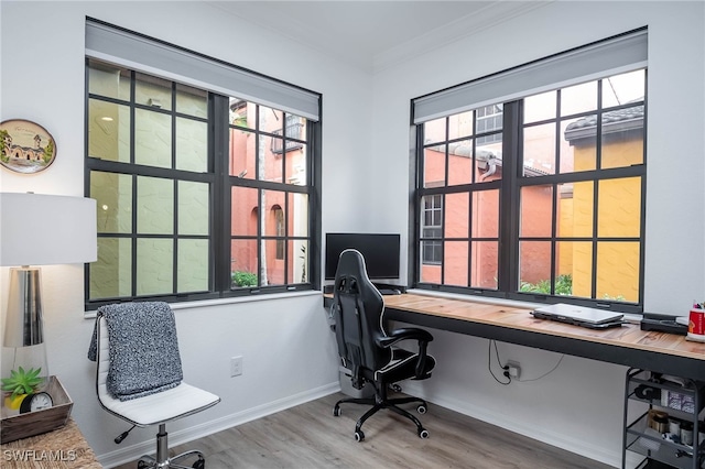 home office with ornamental molding, hardwood / wood-style floors, and a healthy amount of sunlight