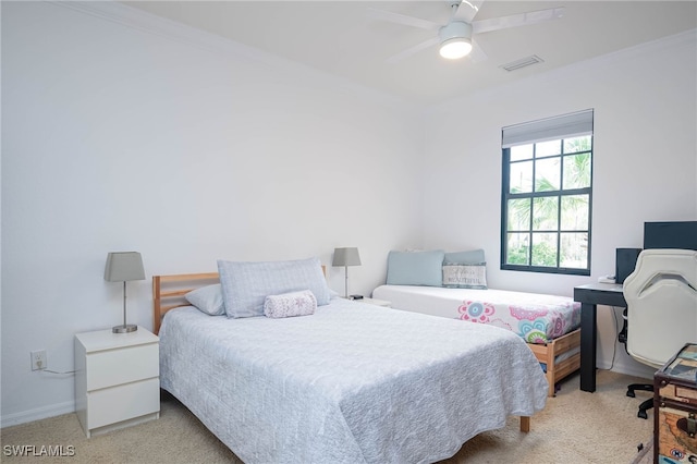 bedroom featuring ornamental molding, light colored carpet, and ceiling fan