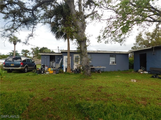 rear view of property with a yard