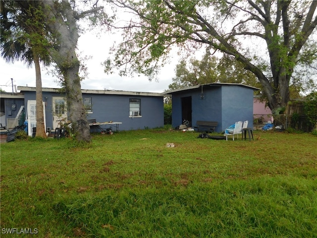 rear view of house with a lawn