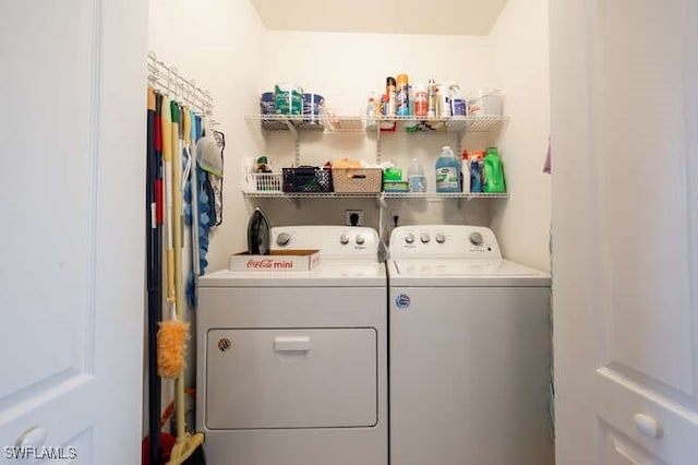 clothes washing area featuring independent washer and dryer