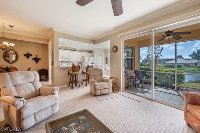 living room with a water view, ceiling fan, ornamental molding, and carpet floors