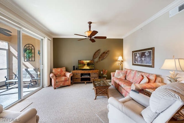 carpeted living room featuring ornamental molding and ceiling fan