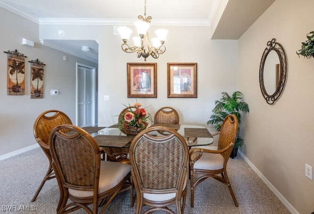 dining space with crown molding, carpet floors, and a chandelier