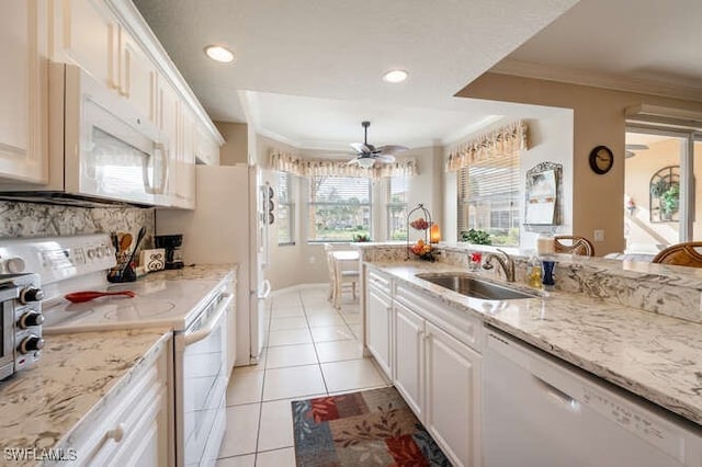 kitchen featuring white appliances, ornamental molding, sink, and white cabinets