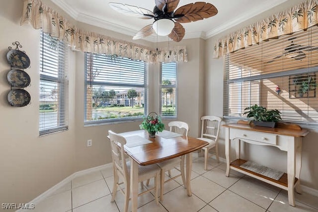 tiled dining area featuring a wealth of natural light, ornamental molding, and ceiling fan