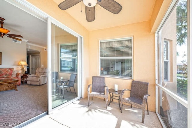 sunroom featuring plenty of natural light and ceiling fan