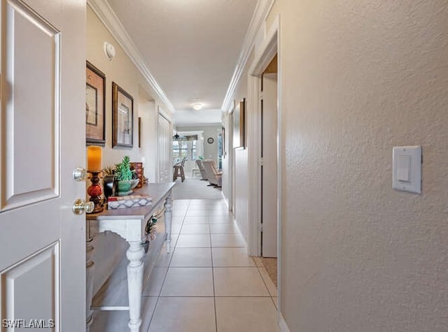 8550 Kingbird Loop Unit 618, Estero, FL 33967 - hallway with a textured wall, ornamental molding, light tile patterned flooring, and baseboards
