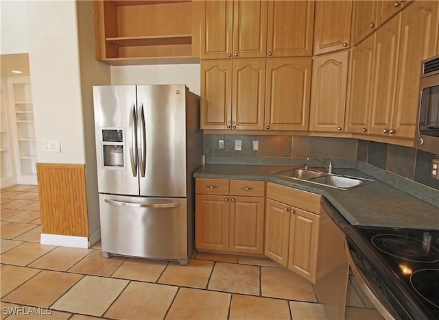 kitchen with backsplash, sink, light tile patterned flooring, and stainless steel appliances