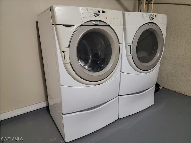 clothes washing area featuring washer and clothes dryer