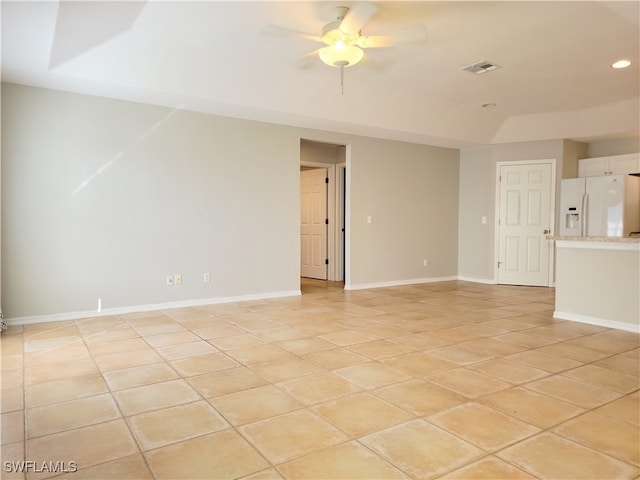 spare room with ceiling fan and light tile patterned floors