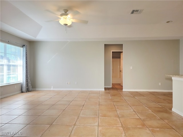 spare room with light tile patterned flooring and ceiling fan