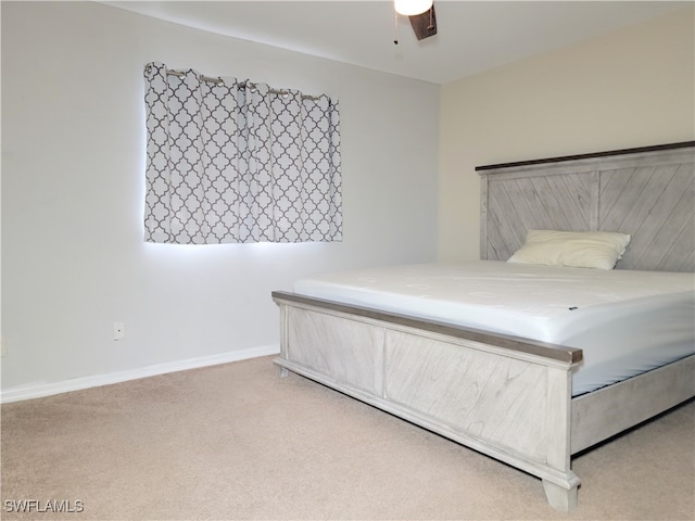 unfurnished bedroom with ceiling fan and light carpet