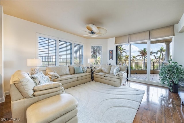 living room with ceiling fan, a healthy amount of sunlight, and dark hardwood / wood-style flooring