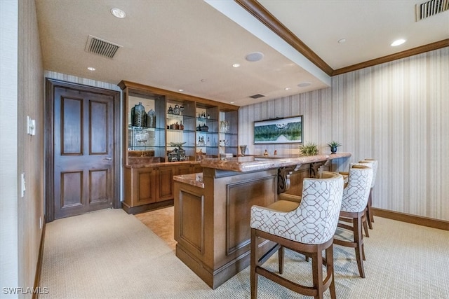 bar with crown molding and light colored carpet