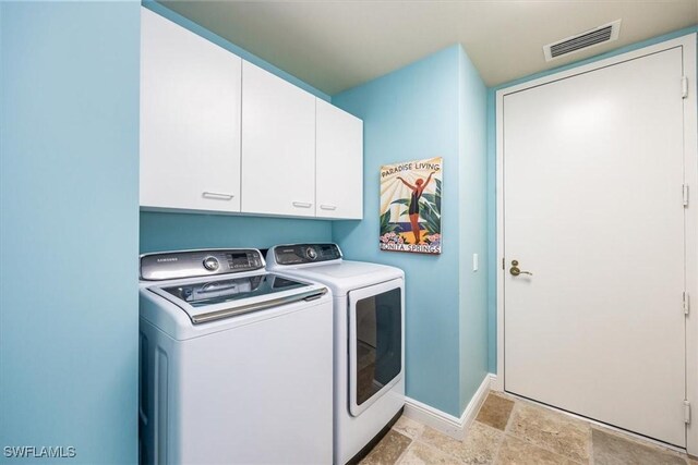 4875 Pelican Colony Blvd Unit 304, Bonita Springs, FL 34134 - laundry area featuring independent washer and dryer, cabinet space, and light stone finish floors