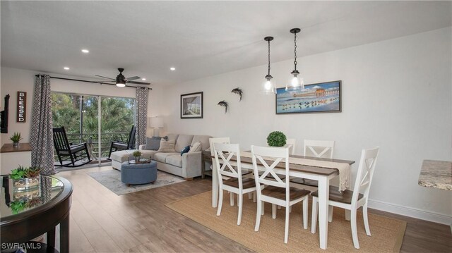 dining room with hardwood / wood-style floors and ceiling fan