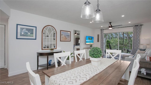 dining area featuring wood-type flooring and ceiling fan