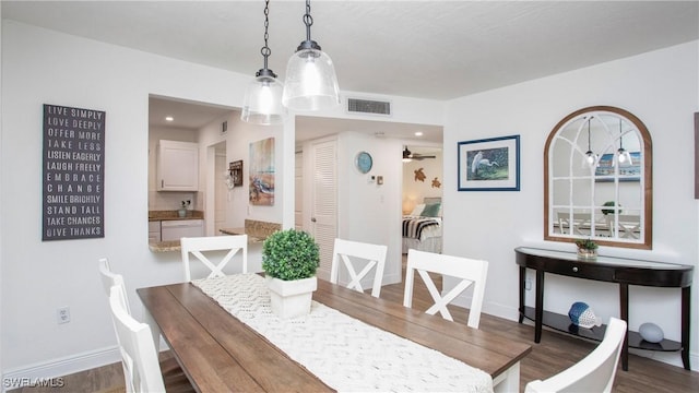 dining area featuring hardwood / wood-style flooring and ceiling fan