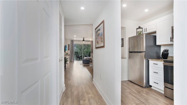 hallway with light hardwood / wood-style flooring