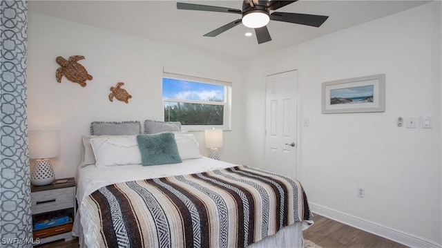 bedroom featuring ceiling fan and dark hardwood / wood-style flooring