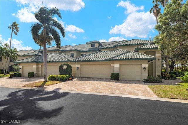 mediterranean / spanish house with a garage