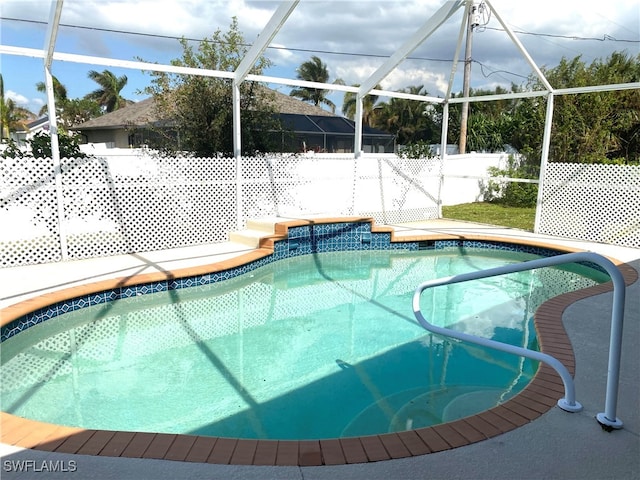 view of pool featuring a fenced in pool, a lanai, and fence