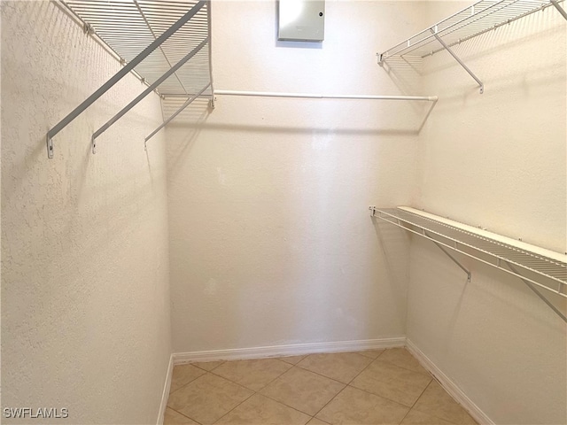 spacious closet with tile patterned floors