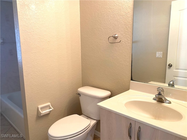 bathroom with vanity, toilet, and a washtub