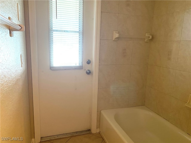 bathroom with a bathtub and plenty of natural light