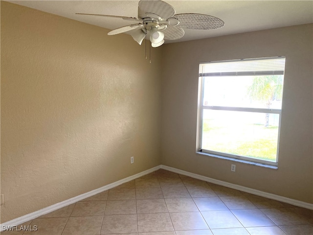 tiled empty room with ceiling fan