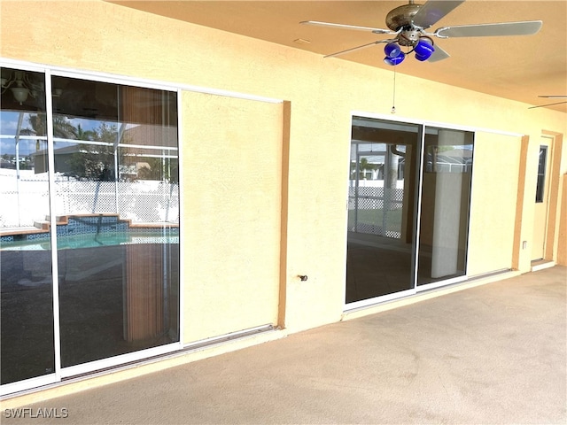 doorway to property featuring ceiling fan and a patio area