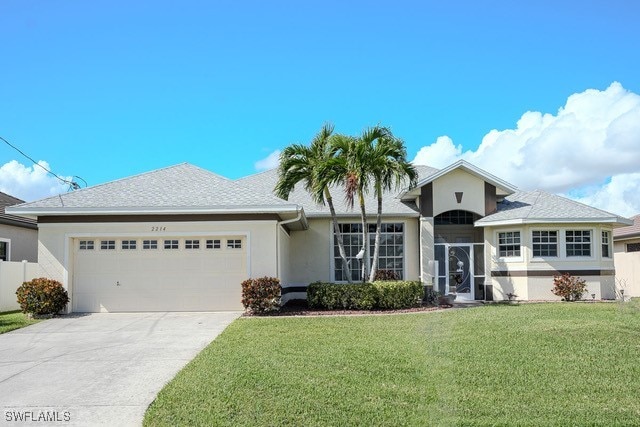 view of front facade featuring a front lawn and a garage