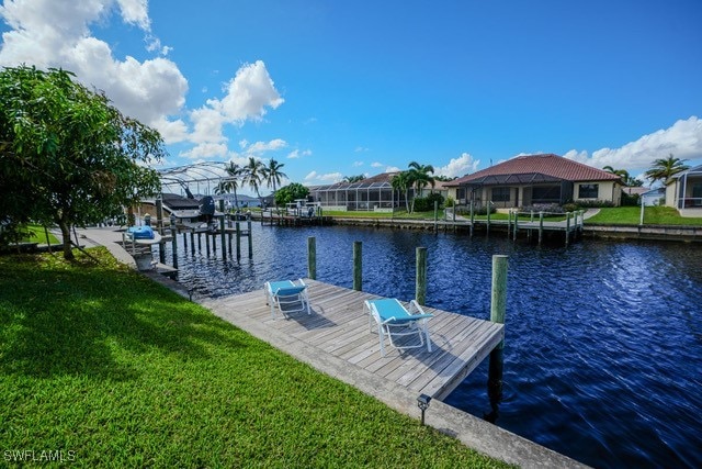 dock area featuring a water view and a yard