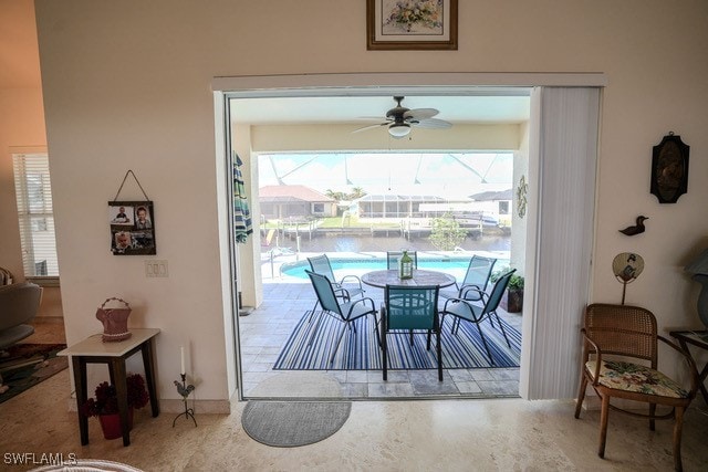 carpeted dining area with ceiling fan