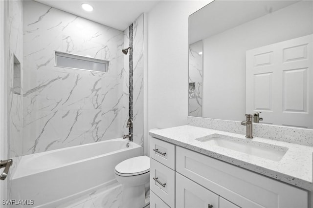 full bathroom with tiled shower / bath combo, vanity, and toilet