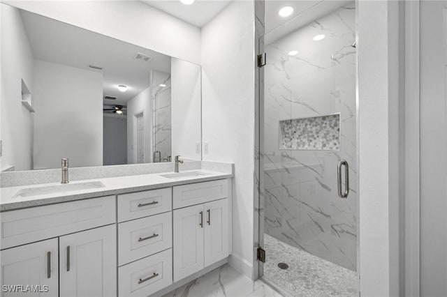 bathroom featuring a shower with shower door, vanity, and ceiling fan