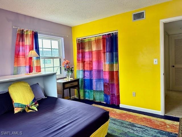 bedroom with a closet and a textured ceiling