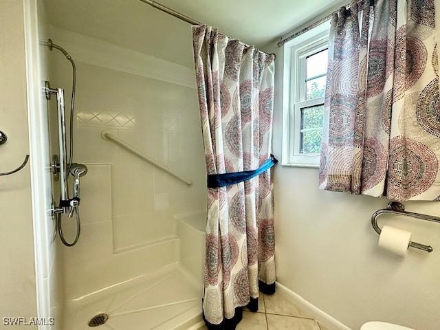 bathroom with tile patterned floors and curtained shower